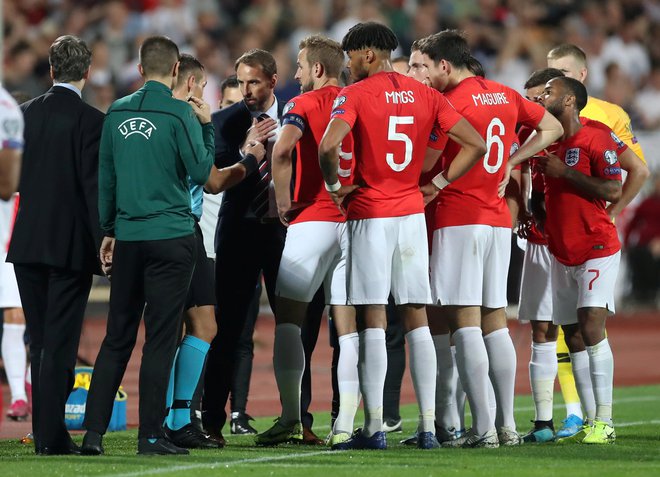 Takole so se angleški nogometaši in selektor Gareth Southgate med prekinitvijo dvoboja proti Bolgarom pred dvema tednoma v Sofiji pogovarjali s sodnikom Ivanom Bebekom. FOTO: Reuters