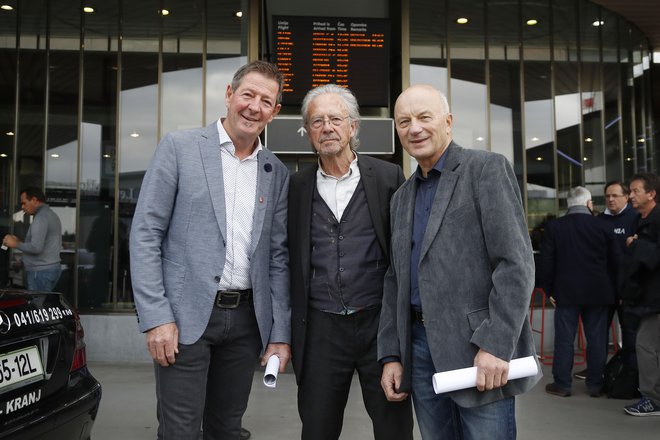 Peter Handke (na sredini) je včeraj preko Brnika pripotoval v rojstno okolje. FOTO: Leon Vidic/Delo