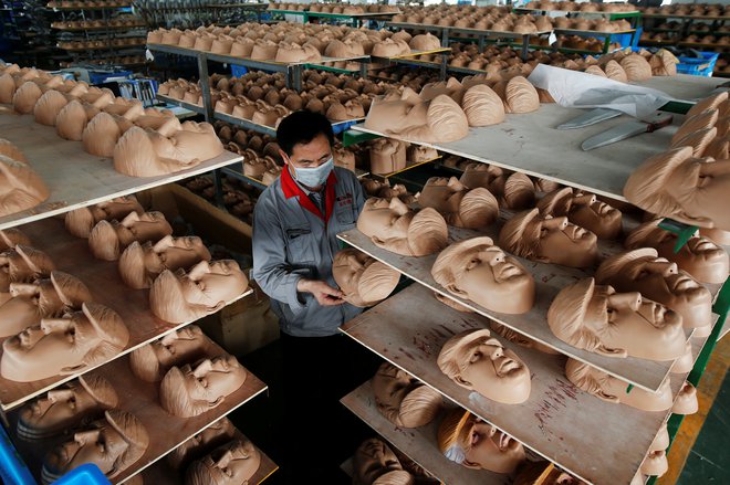 A worker checks a mask of U.S. Republican presidential candidate Donald Trump at Jinhua Partytime Latex Art and Crafts Factory in Jinhua, Zhejiang Province, China, May 25, 2016. There's no masking the facts. One Chinese factory is expecting Donald Trump to beat his likely U.S. presidential rival Hilary Clinton in the popularity stakes. At the Jinhua Partytime Latex Art and Crafts Factory, a Halloween and party supply business that produces thousands of rubber and plastic masks of everyone from Osama Bin Laden to Spiderman, masks of Donald Trump and Democratic frontrunner Hillary Clinton faces are being churned out. Sales of the two expected presidential candidates are at about half a million each but the factory management believes  Trump will eventually run out the winner. "Even though the sales are more or less the same, I think in 2016 this mask will completely sell out," said factory manager Jacky Chen, indicating a Trump mask. REUTERS/Aly Song SEARCH "JINHUA MASK" FOR THIS STORY. SEARCH "THE WIDER IMAGE" FOR ALL STORIES.   TPX IMAGES OF THE DAY - S1BETGGLWXAA