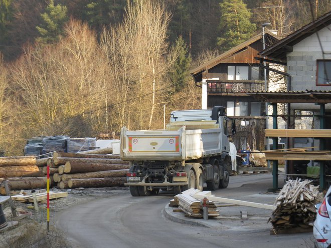 Tudi štiriosni tovornjaki vozijo po ozki cesti mimo hiš skozi Jesenje. FOTO: Bojan Rajšek/Delo