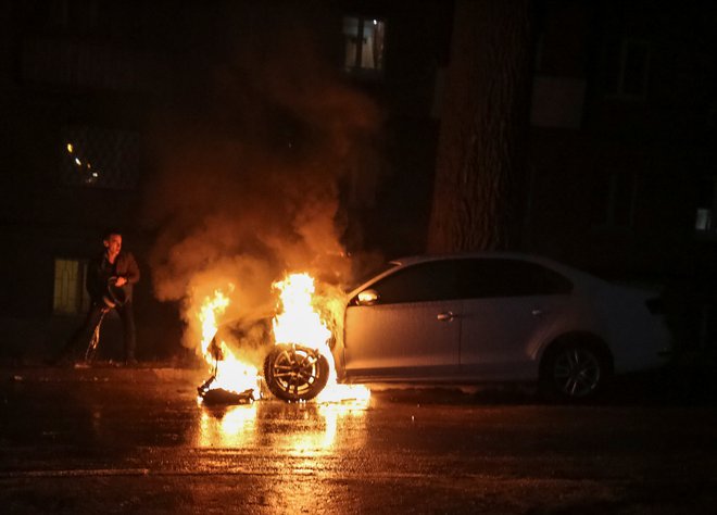 Protestniki so zažgali diplomatski avtomobil. FOTO: Stringer/Reuters