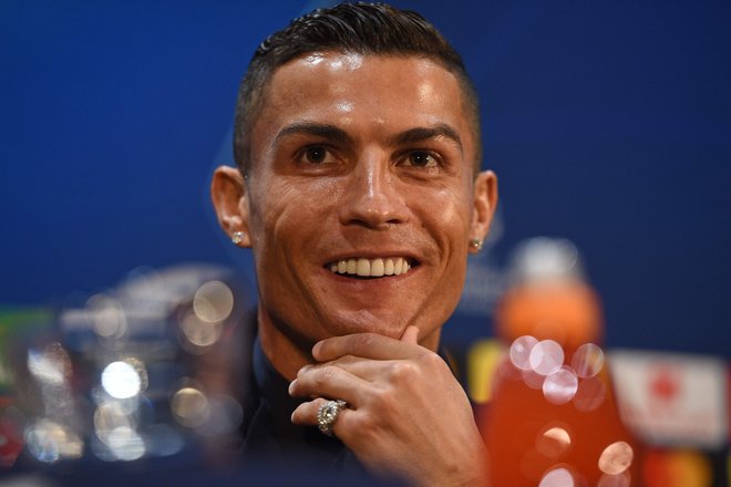 Cristiano Ronaldo je na novinarski konferenci večkrat poudaril, da je srečen človek. FOTO: AFP