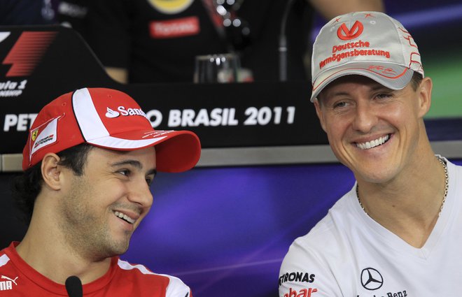 Felipe Massa (levo) močno upa, da se bo Michael Schumacher nekega lepega dne spet pojavil na dirkališču. FOTO: Reuters