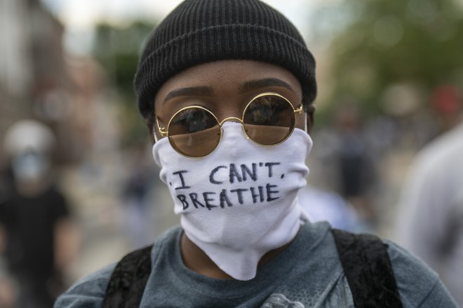 Protestnik z masko, na kateri so zapisane zadnje besede Georgea Floyda &quot;Ne morem dihati!&quot;&nbsp;Foto Mark Makela Afp