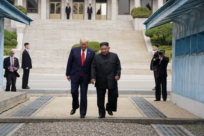 Donald Trump in Kim Džong Un sta skupaj stopila čez mejo. FOTO: Reuters