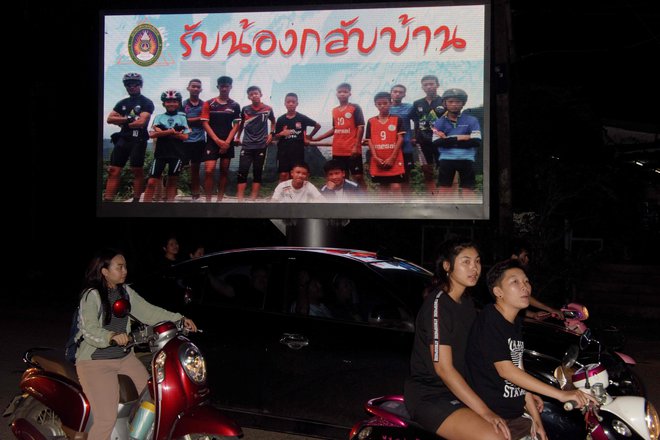 Plakat nogometne ekipe Divjih prašičkov in njihovega trenerja. &raquo;Dobrodošli doma,&laquo; so jim sporočili s plakatom.&nbsp;<br />
FOTO: AFP