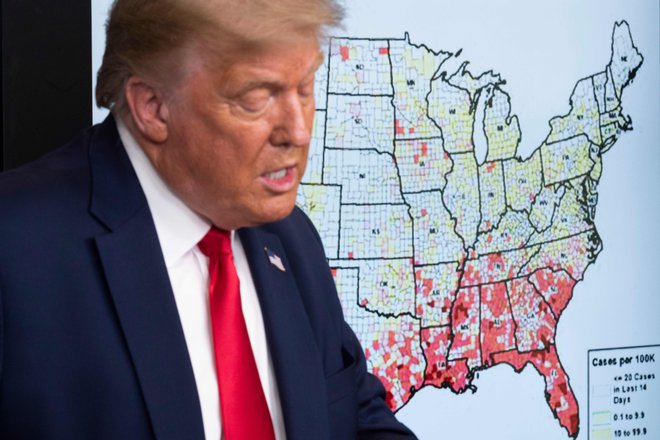Ameriški predsednik Donald Trump pred zdravstvenim zemljevidom svoje države. FOTO: Jim Watson/AFP