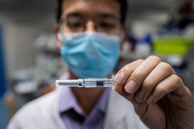 V kitajskem farmacevtskem podjetju Sinovac v Pekingu cepivo, ki ga že preizkušajo na ljudeh, razvijajo po klasičnem principu inaktiviranega virusa. FOTO: Nicolas Asfouri/AFP