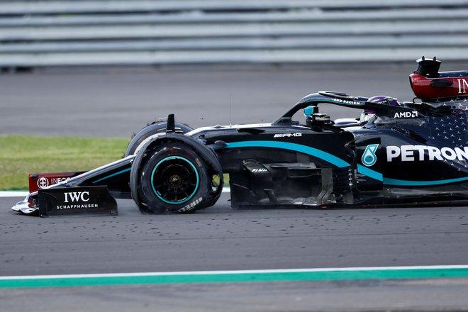 Lewis Hamilton se je v cilj pripeljal s počeno gumo. FOTO: Andrew Boyers/AFP