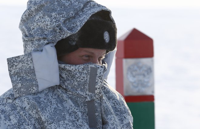 Ruski vojak straži mejno obeležje na oddaljenem arktičnem otočju Dežela Franca Jožefa. FOTO: Reuters