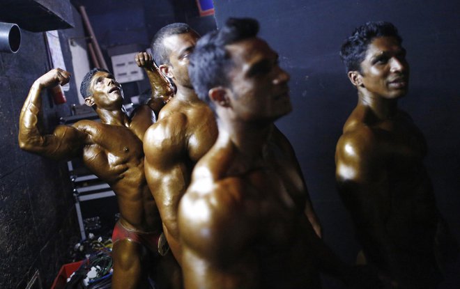 Competitors wait to get on the stage during a bodybuilding competition in Mumbai November 27, 2013. Around 30 bodybuilders from all parts of India participated in the competition. REUTERS/Danish Siddiqui (INDIA - Tags: SPORT SOCIETY)