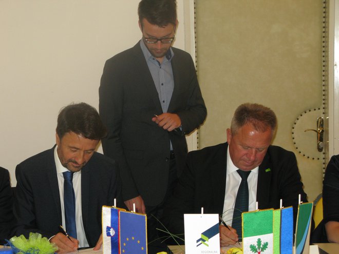 Predsedujoči razvojnega sveta zasavske regije Matjaž Švagan (levo) in gospodarski minister Zdravko Počivalšek podpisujeta dogovor za razvoj Zasavja. FOTO: Polona Malovrh/