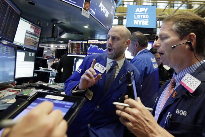 Specialist Meric Greenbaum, center, works with traders at his post on the floor of the New York Stock Exchange, Tuesday, May 29, 2018. U.S. stocks are opening lower, following sharp drops in Europe triggered by political uncertainty in Italy. (AP Photo/Richard Drew)