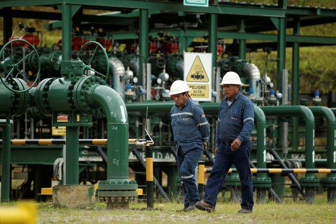 Uslužbenca državnega naftnega podjetja Petroamazonas blizu nacionalnega parka Yasuní, kjer so začeli črpati nafto pred dvema letoma. FOTO: Reuters