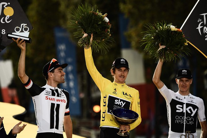 Tour de France 2018 winner Great Britain's Geraint Thomas (C), wearing the overall leader's yellow jersey, second-placed Netherlands' Tom Dumoulin (L) and third-placed Great Britain's Christopher Froome (R) pose on the podium after the 21s