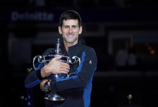 Novak Đoković se je po sezonah 2011 in 2015 še tretjič razveselil dvojčka Wimbledon-OP ZDA. FOTO: Reuters