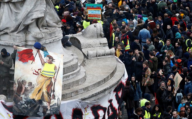 A protester holds a drawing featuring a Marianne with a yellow vest at the Place de la Republique during a national day of protest by the "yellow vests" movement in Paris, France, December 8, 2018. REUTERS/Stephane Mahe - RC17908CCF90