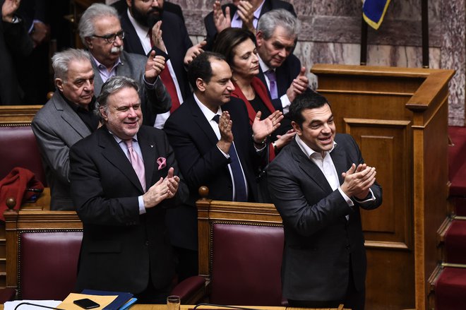 Grški premier Aleksis Cipras skupaj s člani svoje vlade po ratifikaciji prespanskega sporazuma v grškem parlamentu. FOTO: Angelos Tzortzinis/Afp