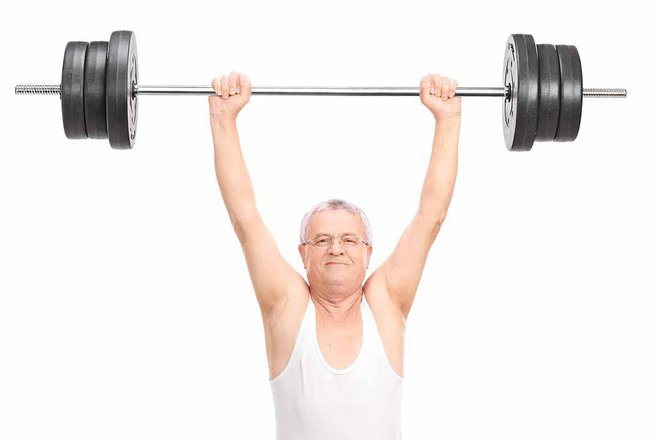 Senior lifting a heavy barbell and looking at the camera isolated on white background