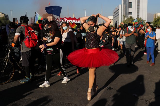 Balerina v plinski maski izvaja elemente baleta na demonstracijah proti čilski vladi v Santiagu de Chile. FOTO: Ivan Alvarado/Reuters