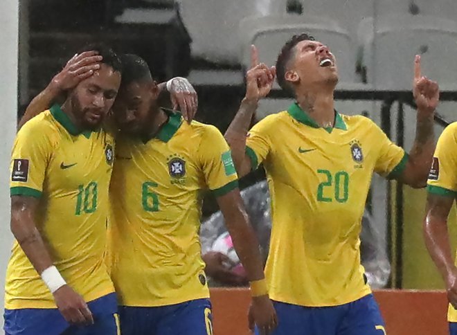 Brazilci in njen napadalec Roberto Firmino (desno) so kvalifikacije za SP začeli prepričljivo. Petkratni svetovni prvaki so s 5:0 odpravili Bolivijo, napadalec Liverpoola pa je dosegel dva gola. FOTO: Amanda Perobelli/AFP