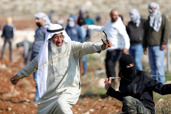 Palestinci so se s fračami zoperstavili izraelski vojski med protestom proti gradnji izraelskih naselij v Deir Jarirju, na zasedenem Zahodnem bregu. FOTO: Mohamad Torokman/Reuters