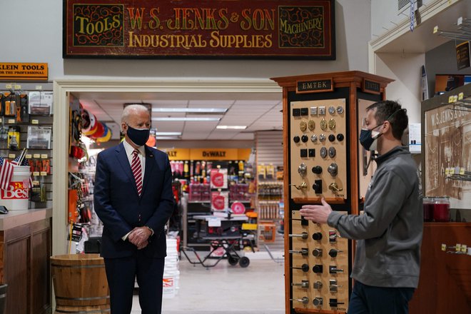 US President Joe Biden (L) visits W.S. Jenks & Son, a hardware store that has benefited from a Paycheck Protection Program (PPP) loan, in Washington, DC, on March 9, 2021. - Biden met with Michael Siegel (R), co-owner of W.S. Jenks & Son, and Mary Anna Ackley, owner of Little Wild Things Farm, a business next door to Jenks & Son which also benefited from the PPP. (Photo by MANDEL NGAN / AFP)