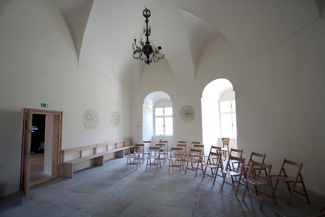 Grajska kapelica ima po obnovi bele stene in moderno opremo iz svetlo rjavega lesa. FOTO: Jože Pojbič/Delo