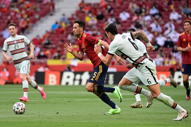 Sergio Busquets (v rdečem dresu) med zadnjim nastopom za špansko reprezentanco na prijateljski tekmi s Portugalsko v Madridu. FOTO: Javier Soriano/AFP