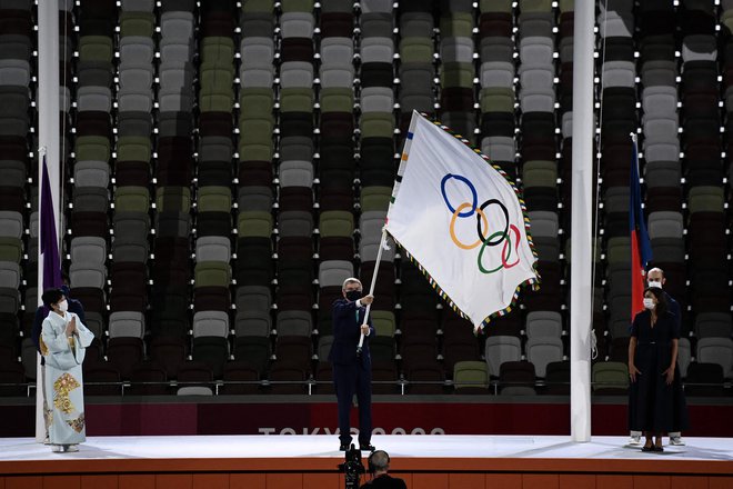 Thomas Bach je zavihtel olimpijsko zastavo. FOTO:  Jewel Samad/AFP