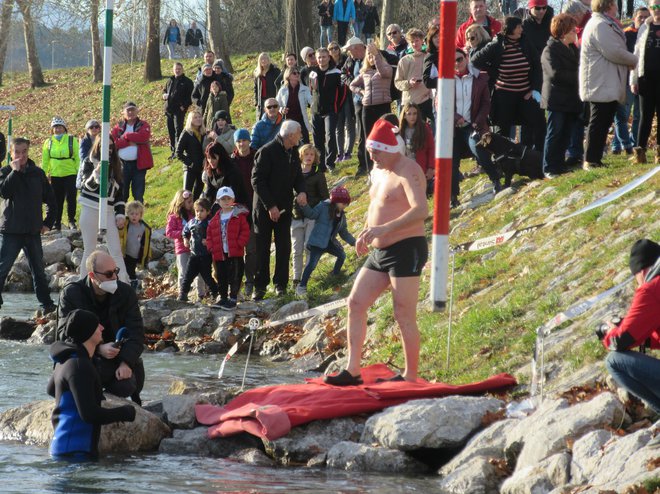 Božičkova kapa za pogum pred skokom v mrzlo reko. FOTO: Špela Kuralt/Delo
