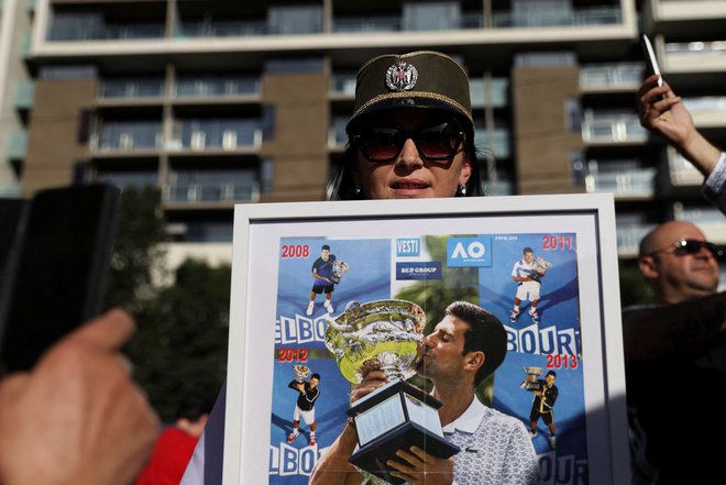 Privrženka Novaka Đokovića pred hotelom Park v Melbournu. FOTO: Loren Elliott/Reuters
