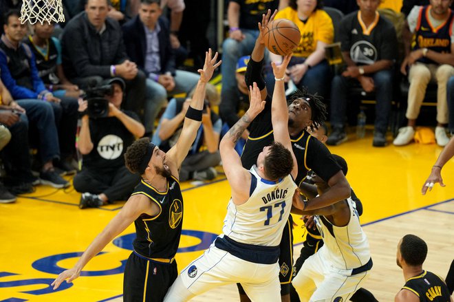 May 18, 2022; San Francisco, California, USA; Golden State Warriors center Kevon Looney (5) blocks a shot by Dallas Mavericks guard Luka Doncic (77) as guard Klay Thompson (11) defends during the first quarter of game one of the 2022 western conference finals at Chase Center. Mandatory Credit: Darren Yamashita-USA TODAY Sports