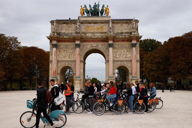 Turisti na kolesu pred Slavolokom zmage. FOTO:&nbsp;Stringer/Reuters
