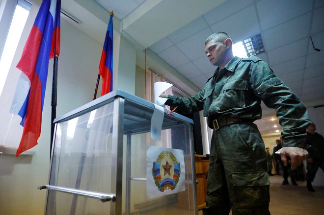 Pripadnik proruske vojske samooklicane Luganske ljudske republike glasuje na referendumu o priključitvi Ruski federaciji. FOTO:&nbsp;Alexander Ermochenko/Reuters

