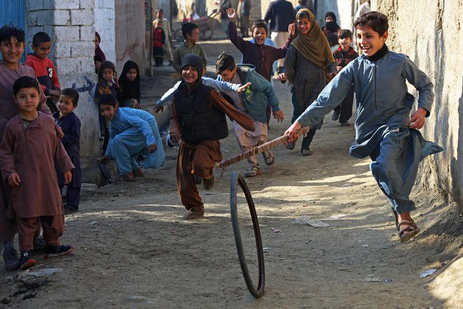 Na ulici v Džalalabadu se afganistanski otroci igrajo s pnevmatiko. Foto: Afp
