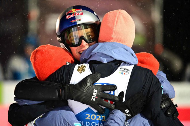 Andreas Wellinger slavi z rojakinjama in rojakom po zmagi. FOTO: Jure Makovec/AFP
