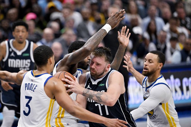 Luka Dončić je bil pogosto obkrožen s tremi košarkarji Golden Stata, desno Stephen Curry. FOTO: Jerome Miron/USA Today Sports
