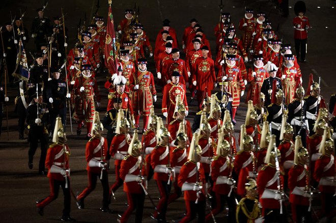 Priprave na kronanje Karla III. so v zadnjih dneh vključevale tudi vaje, v katerih so sodelovali člani britanske vojske v slavnostnih uniformah. FOTO: Henry Nicholls/Reuters