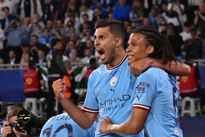 Rodri (na fotografiji levo) se je takole veselil vodilnega gola za Manchester City. FOTO: Franck Fife/AFP