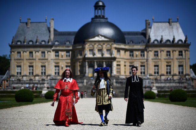 Ljudje oblečeni v kostume iz 17. stoletja, pozirajo na zgodovinskem dogodku »La grande journee des costumés« (veliko popotovanje kostumov), na katerem se je na gradu Vaux-le-Vicomte v Maincyju, približno 50 km od Pariza, zbralo več sto ljudi. Foto: Christophe Archambault/Afp