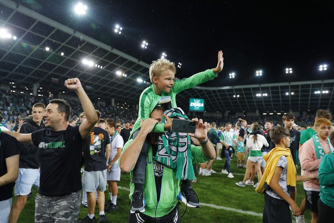 Veseli Olimpijini navijači so šli predaleč z vdorom na igrišče, a je bila Uefa usmiljena in je le denarno kaznovala klub. FOTO: Leon Vidic/Delo