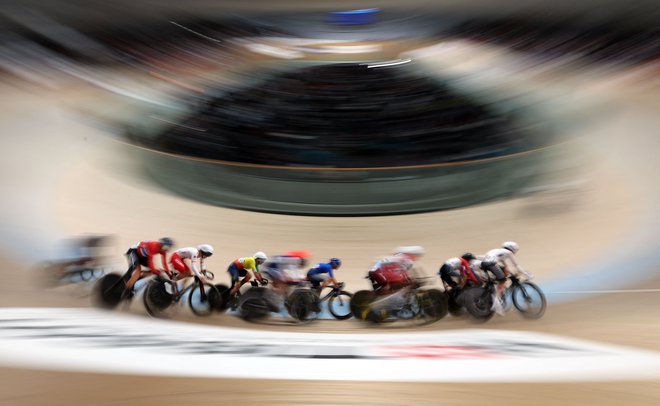 Kolesarji tekmujejo na elitni izločilni dirki na velodromu Sir Chris Hoy med kolesarskim svetovnim prvenstvom UCI v Glasgowu na Škotskem. Foto: Adrian Dennis/Afp