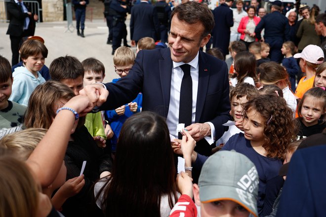 Francoski predsednik Emmanuel Macron med šolarji. FOTO: Raphael Lafargue/Afp