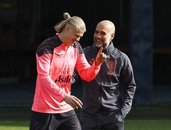 Pep Guardiola (desno) in njegov najdražji eksponat v Manchester Cityju Erling Haaland. FOTO: Jason Cairnduff/Reuters