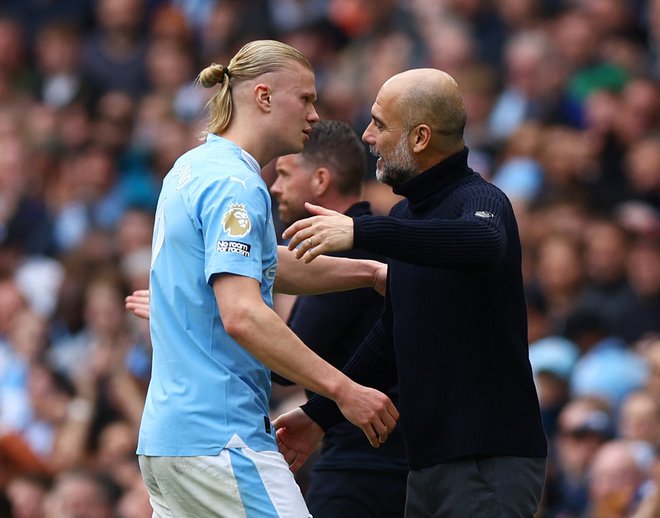 Pep Guardiola in Erling Haaland kujeta načrt za skalp Reala. FOTO: Molly Darlington/Reuters