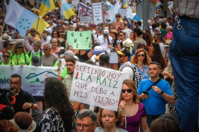 Na tisoče prebivalcev Kanarskih otokov je na demonstracijah zahtevalo model turizma, ki spoštuje okolje in njihove prebivalce. »Danes branimo svoje korenine,« je bil eden od napisov demonstrantov. FOTO: Desiree Martin/AFP