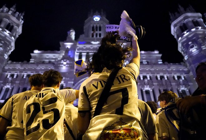 Slavje (brez nogometašev, ki se pripravljajo na tekmo z Bayernom) se je začelo pred fontano Cibelles, nadaljevalo pa tudi pred mestno hišo v Madridu. Foto Ana Beltran/Reuters