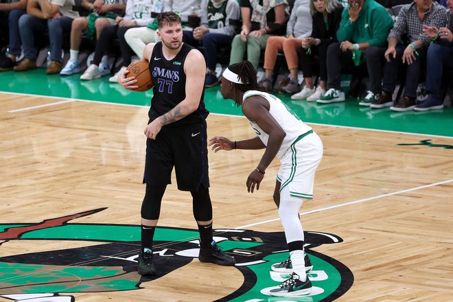 BOSTON, MASSACHUSETTS - JUNE 06: Luka Doncic #77 of the Dallas Mavericks looks to pass against Jrue Holiday #4 of the Boston Celtics during the third quarter in Game One of the 2024 NBA Finals at TD Garden on June 06, 2024 in Boston, Massachusetts. NOTE TO USER: User expressly acknowledges and agrees that, by downloading and or using this photograph, User is consenting to the terms and conditions of the Getty Images License Agreement.   Adam Glanzman/Getty Images/AFP (Photo by Adam Glanzman / GETTY IMAGES NORTH AMERICA / Getty Images via AFP)