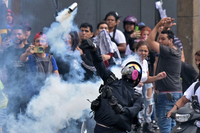 Protesti, ki so v Venezueli izbruhnili po sporni zmagi sedanjega predsednika Nicolasa Madura na nedeljskih predsedniških volitvah, so v ponedeljek zahtevali najmanj dve smrtni žrtvi. Venezuelski predsednik je sporočil, da se bo policija ostro odzvala na proteste. Foto: Yuri Cortez/Afp
